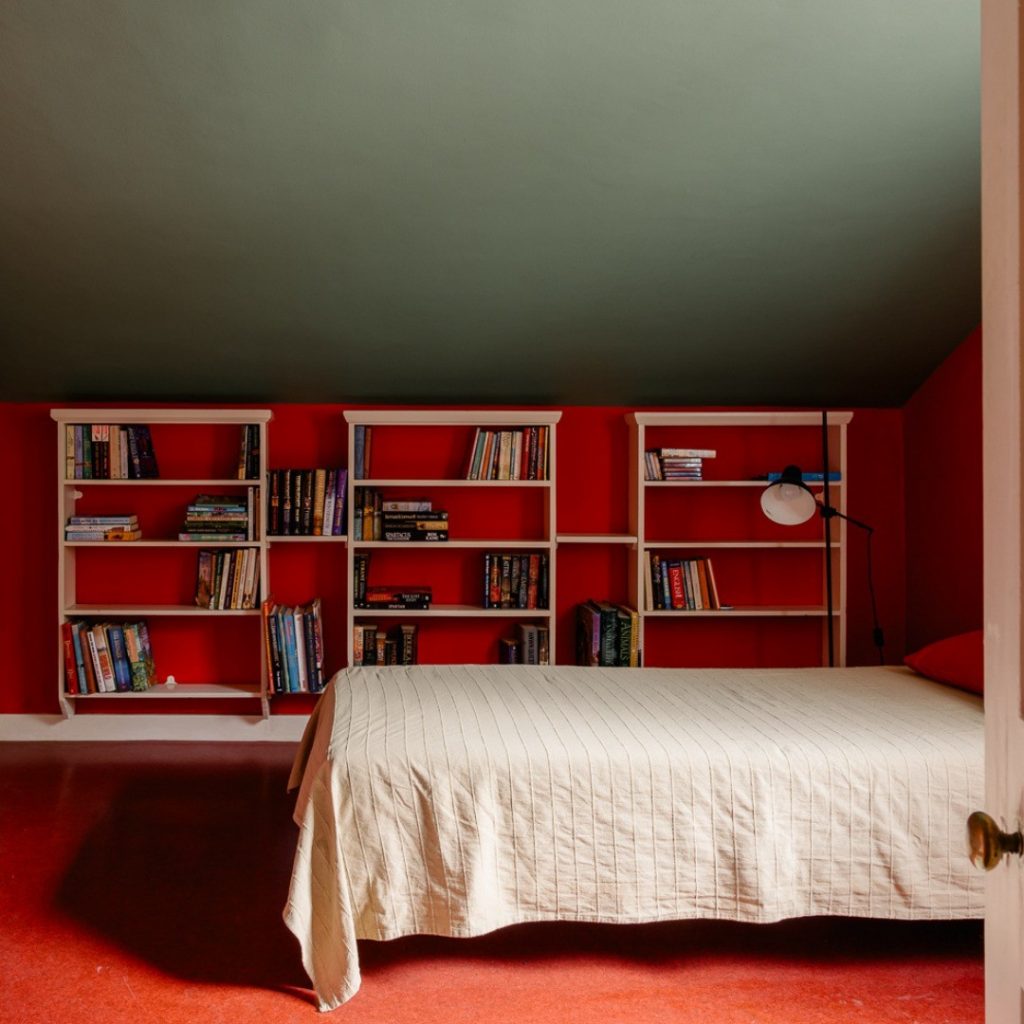 Attic bedroom with red walls and floor