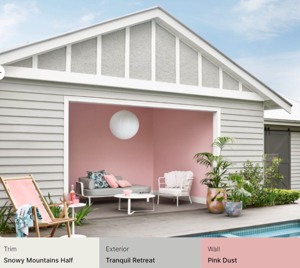  exterior of this poolhouse uses Dulux Snowy Mountains Half on the trim with grey for the exterior in Tranquil Retreat and pink walls using Dulux Pink Dust