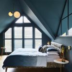 A Sophisticated Bedroom with Attic-Inspired Architecture in Dusty Blue