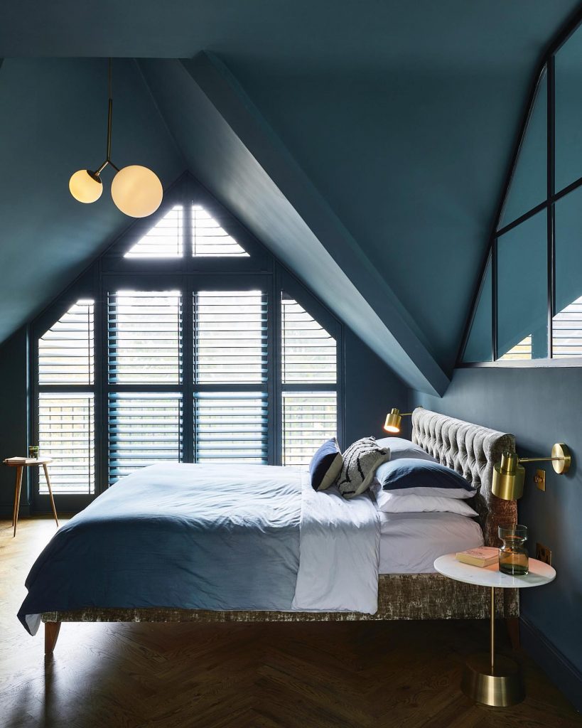A Sophisticated Bedroom with Attic-Inspired Architecture in Dusty Blue