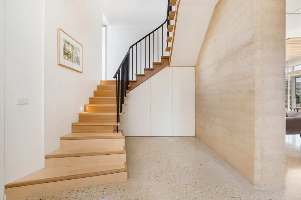 blonde wood staircase and polished concrete floors
