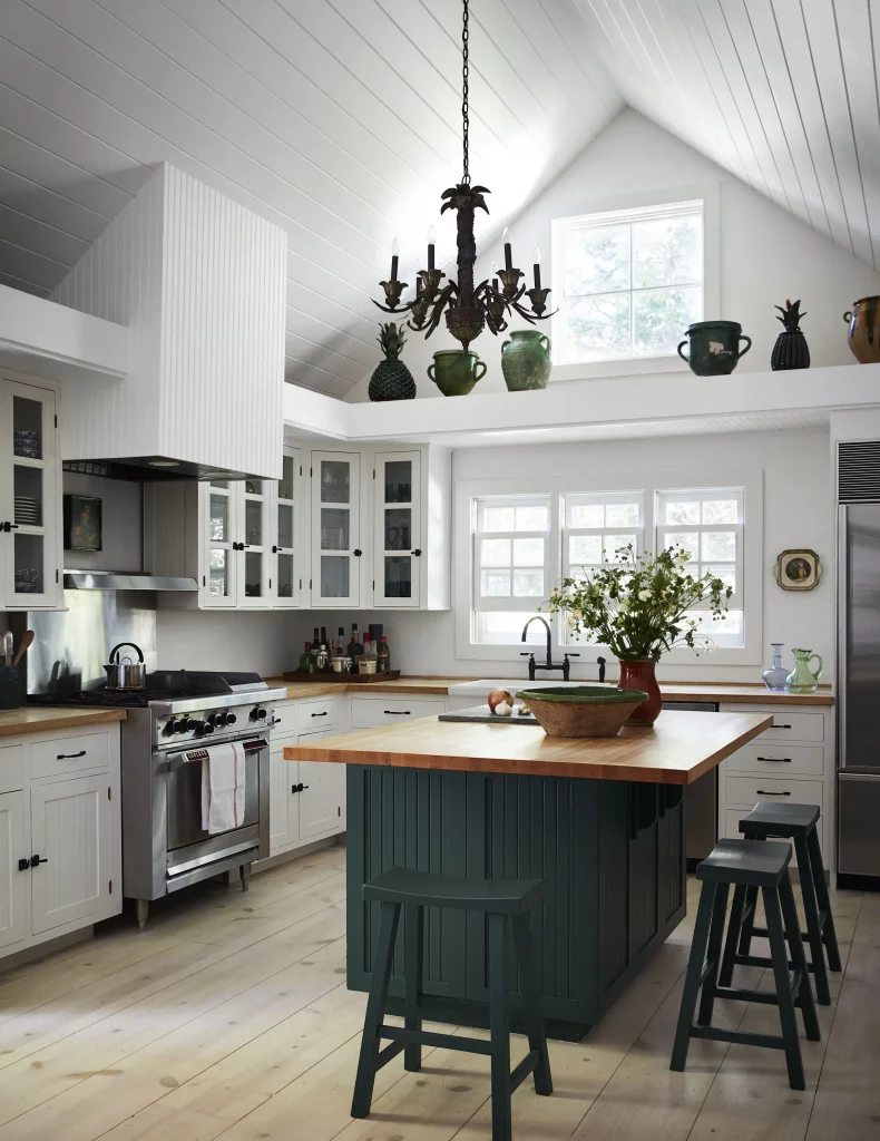 dark green kitchen island with white kitchen cabinets