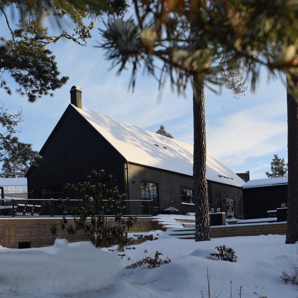 modern farmhouse in black in the snow
