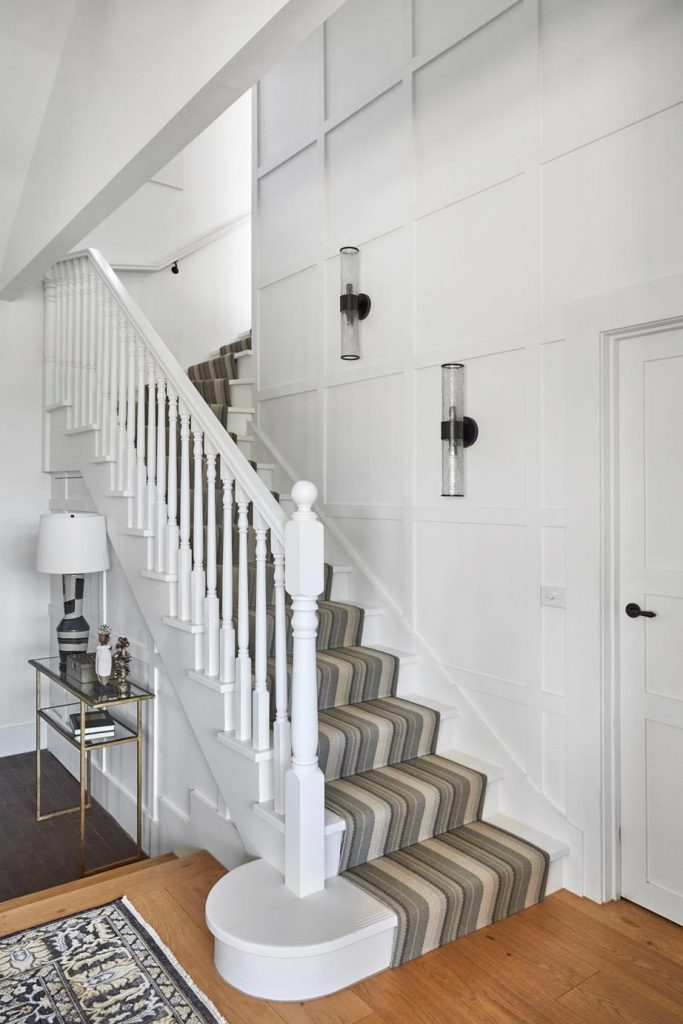white staircase with carpet runner
